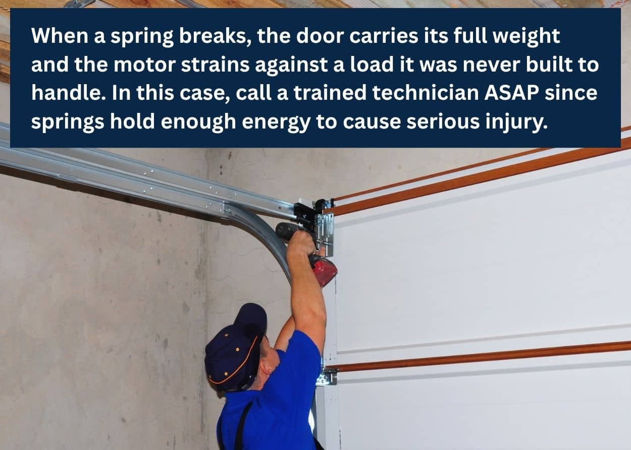 Garage door technician repairing a broken spring and track system inside a residential garage